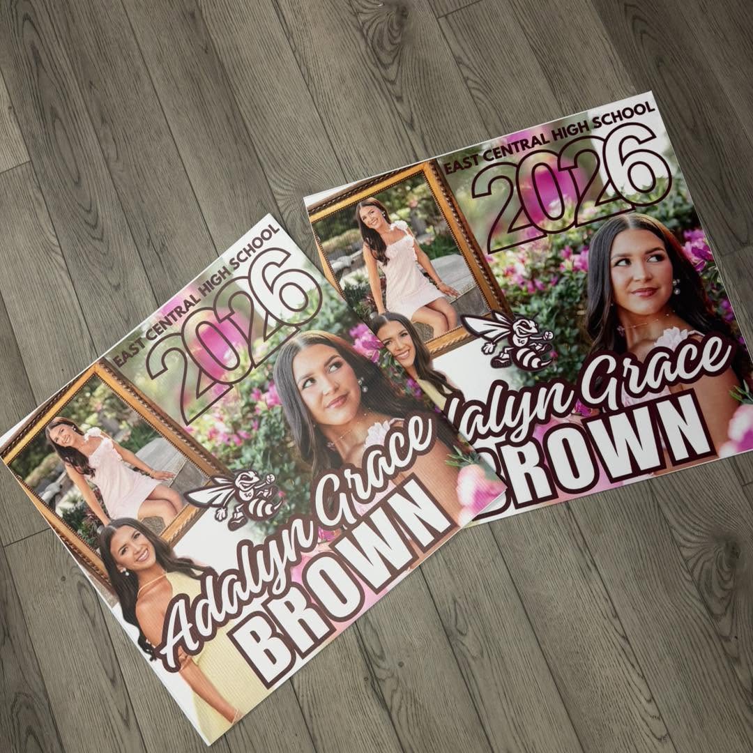 Two printed senior graduation yard signs with photos