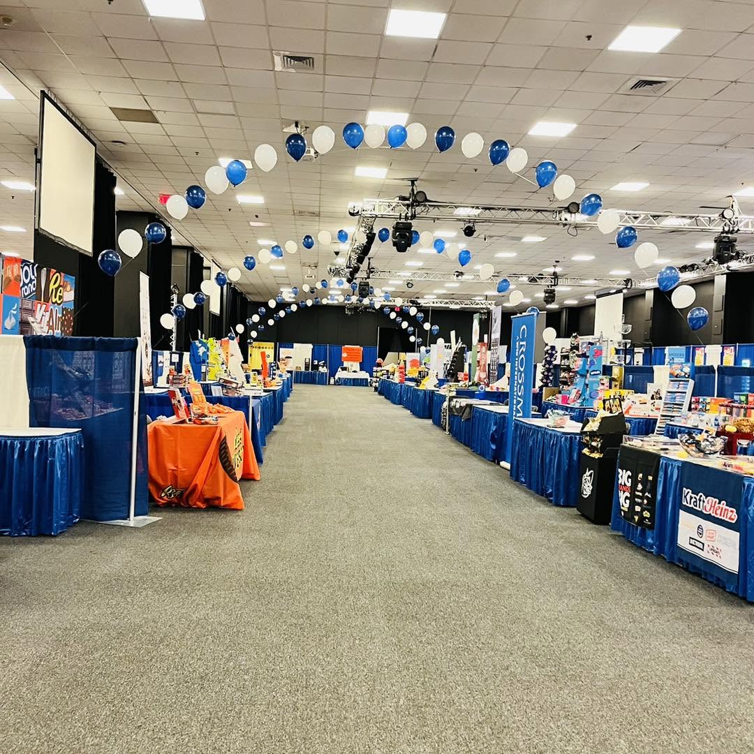 Balloon décor — Ceiling balloon garlands over a convention floor