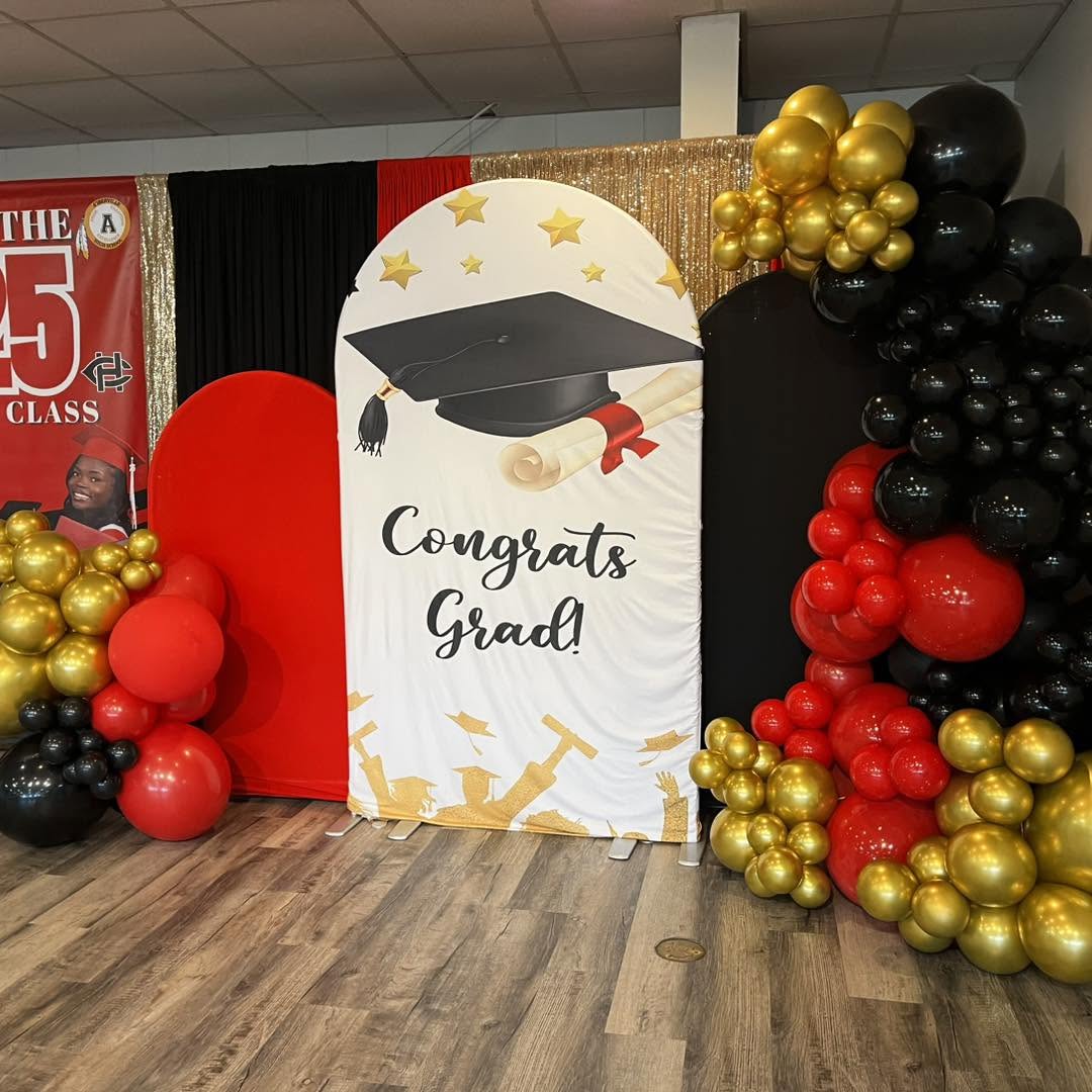 Graduation backdrop with red, black and gold balloons