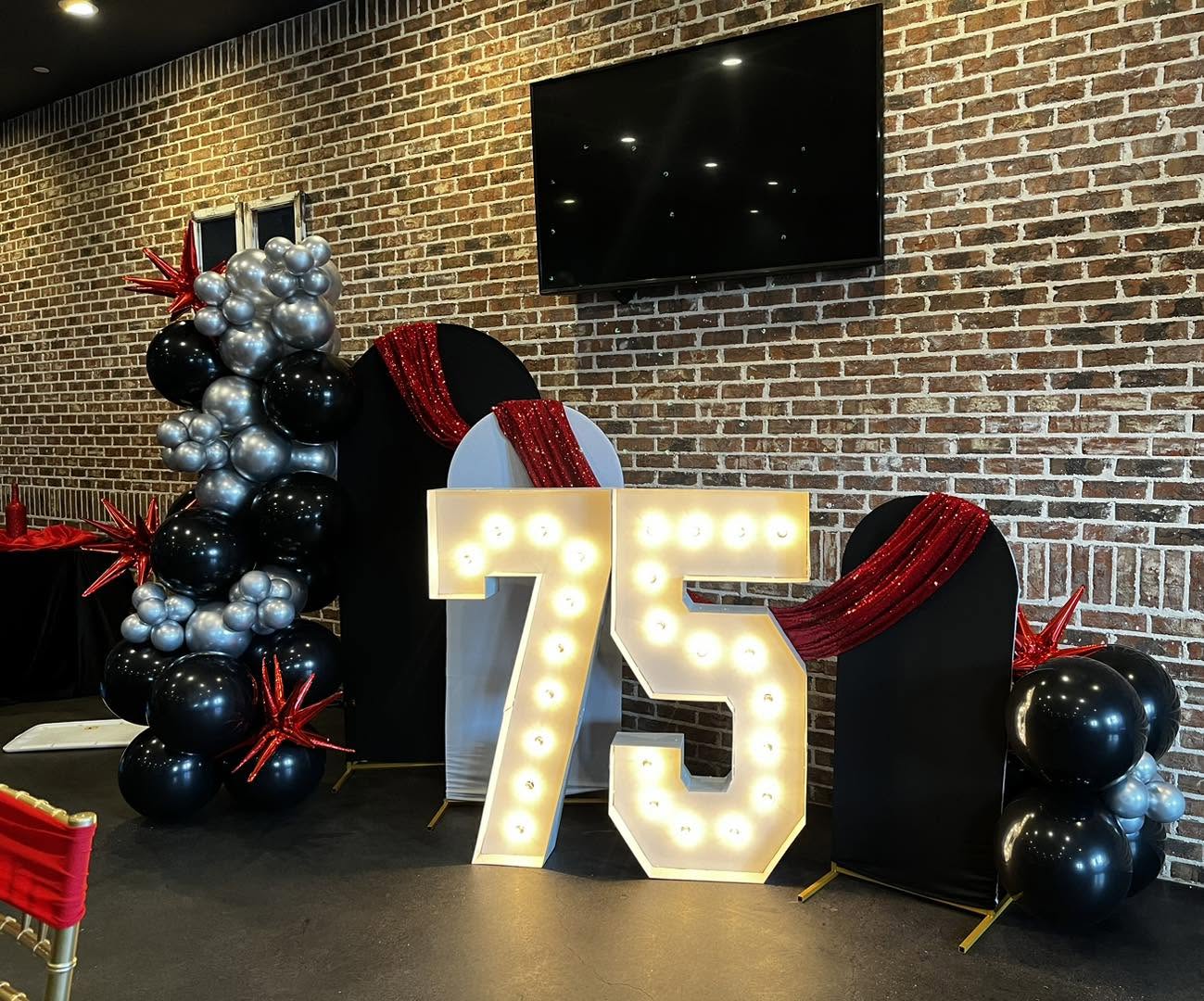 Marquee 75 with black, silver and red balloon columns
