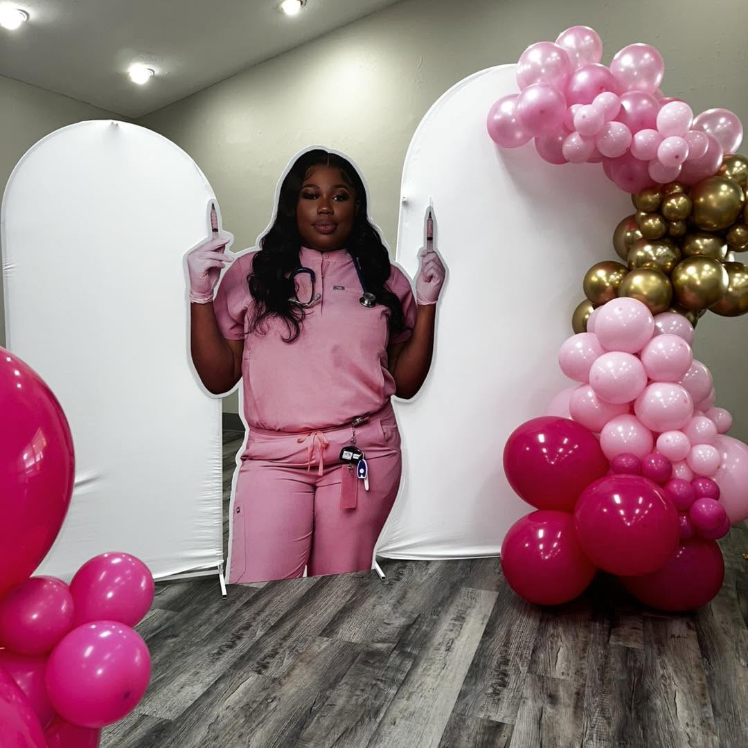 Custom nurse portrait cut-out prop with pink and gold balloon garland