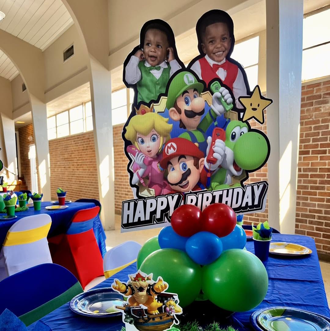 Super Mario themed cut-out prop display with balloon centerpiece