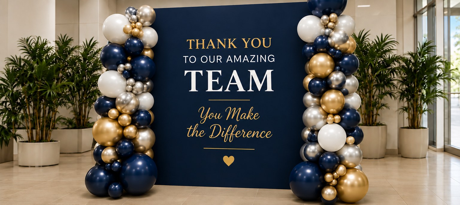 Navy and gold balloon columns framing a Thank You To Our Amazing Team backdrop
